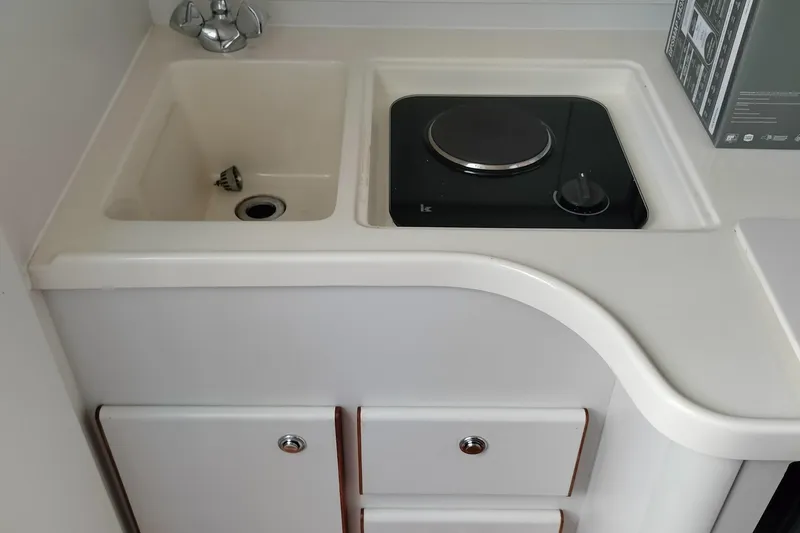 Slide: The Image of 1995 Tiara Yachts 2900 Open galley with sink and stovetop. - 11