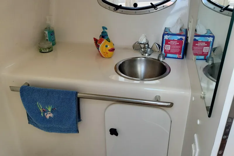 Slide: The Image of 1995 Tiara Yachts 2900 Open bathroom with sink, mirror, and decorative items. - 12