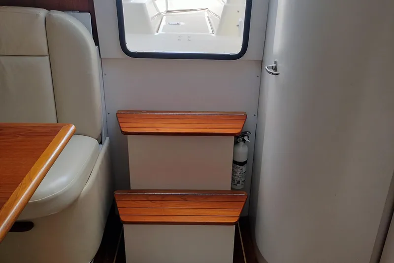 Slide: The Image of Interior of 1995 Tiara Yachts 2900 Open with wooden steps and seating area. - 13