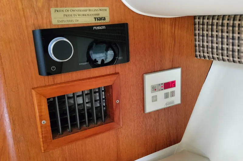 Slide: The Image of Control panel and vent inside a 1995 Tiara Yachts 2900 Open, featuring a Fusion stereo system. - 14