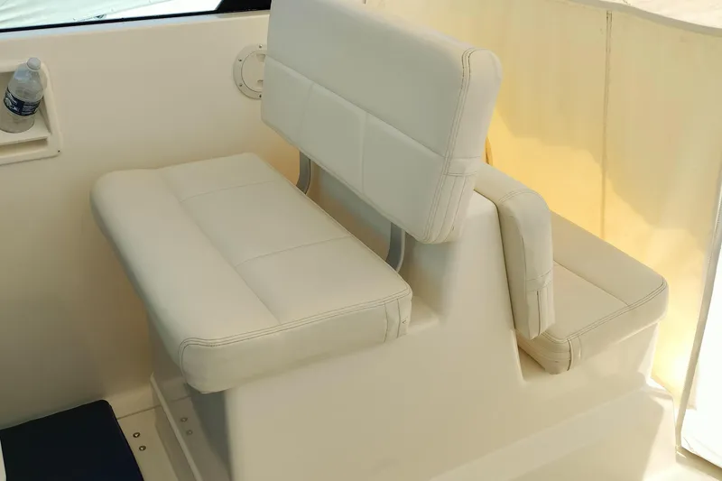 Slide: The Image of White leather seating on a 1995 Tiara Yachts 2900 Open boat interior. - 15