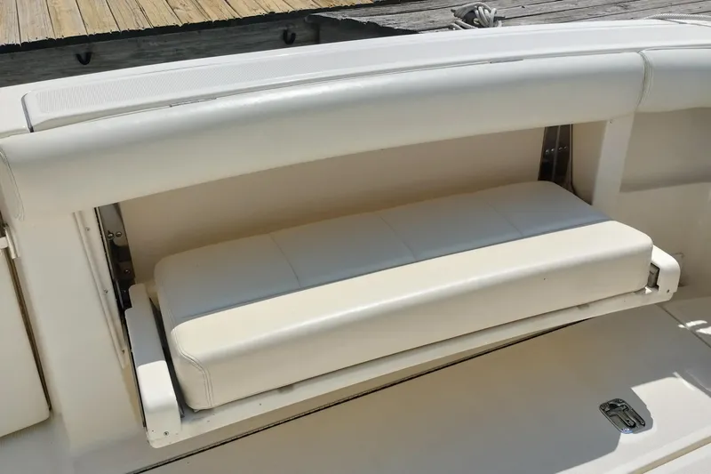 Slide: The Image of 1995 Tiara Yachts 2900 Open, white cushioned bench seat on deck. - 18