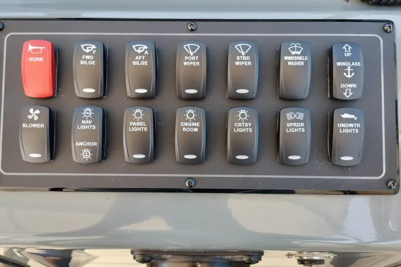Slide: The Image of Control panel of a 1995 Tiara Yachts 2900 Open with labeled switches. - 25