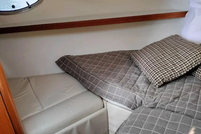 Slide: The Image of 1995 Tiara Yachts 2900 Open cabin interior with checkered bedding and cushions. - 26