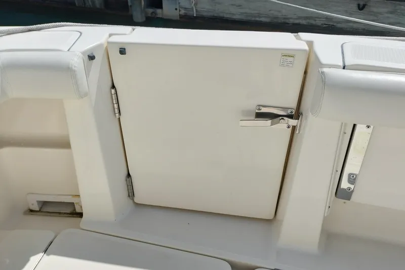 Slide: The Image of 1995 Tiara Yachts 2900 Open boat hatch with secure latch and white seating. - 3