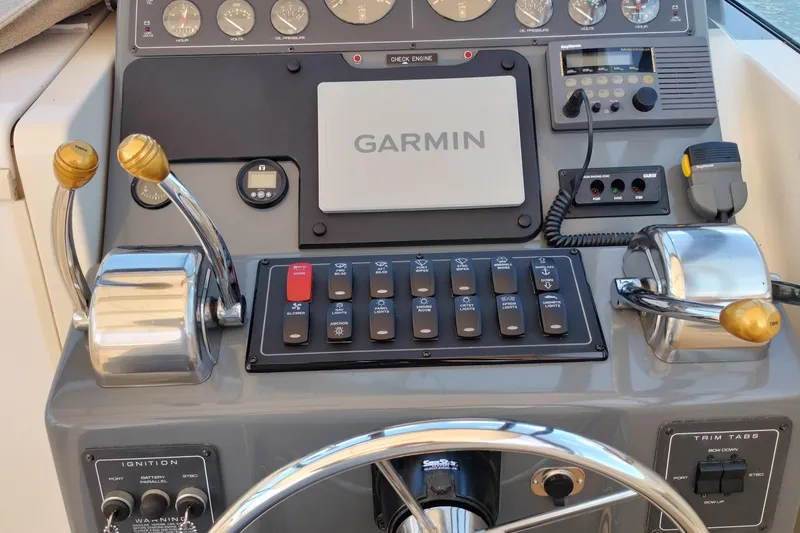 Slide: The Image of 1995 Tiara Yachts 2900 Open dashboard with Garmin navigation and control panel. - 4