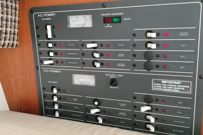 Slide: The Image of Electrical control panel on a 1995 Tiara Yachts 2900 Open boat, featuring AC and DC power switches. - 5