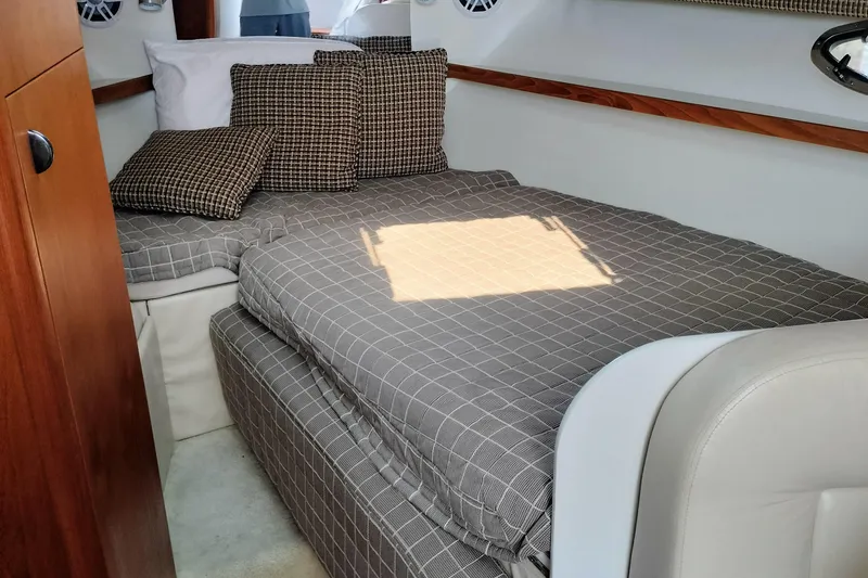 Slide: The Image of 1995 Tiara Yachts 2900 Open cabin interior with checkered bedding and cushions. - 7