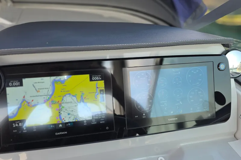 Slide: The Image of Dashboard of a 2022 Regal 28 Express boat with Garmin navigation displays. - 18