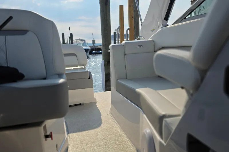 Slide: The Image of 2022 Regal 28 Express boat interior with comfortable seating at a marina. - 20