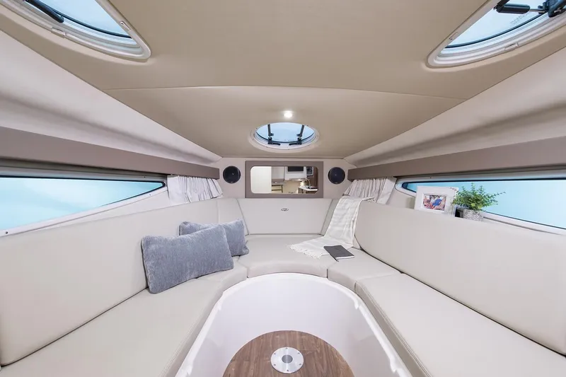 Slide: The Image of Manufacturer Provided Image: Luxurious interior of 2022 Regal 28 Express boat with beige seating and skylights. - 24