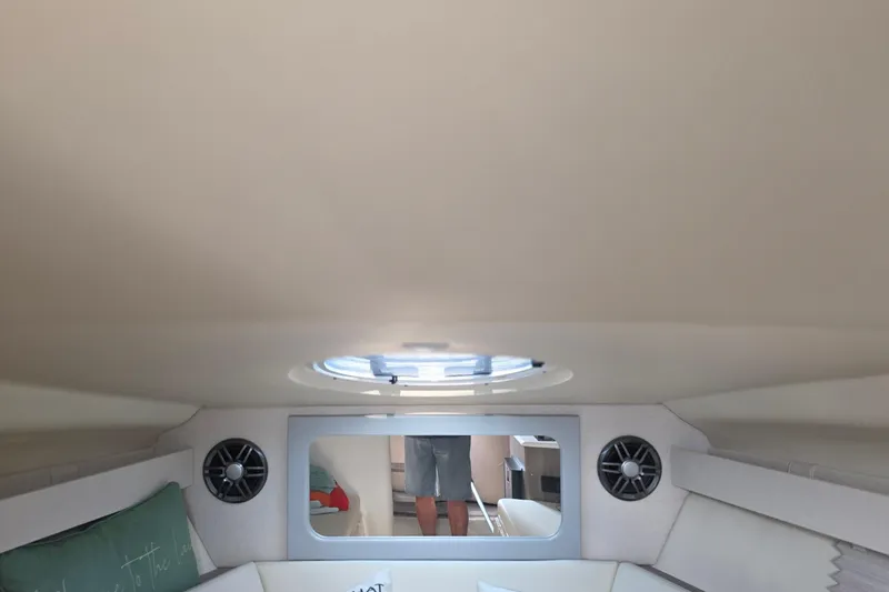 Slide: The Image of Interior cabin of 2022 Regal 28 Express boat with speakers and skylight. - 29