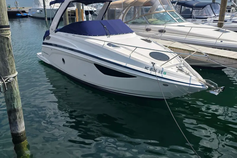 Slide: The Image of 2022 Regal 28 Express boat docked in a marina with clear water. - 3