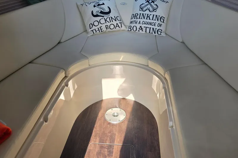 Slide: The Image of Interior of 2022 Regal 28 Express boat with cozy seating and nautical-themed pillows. - 32