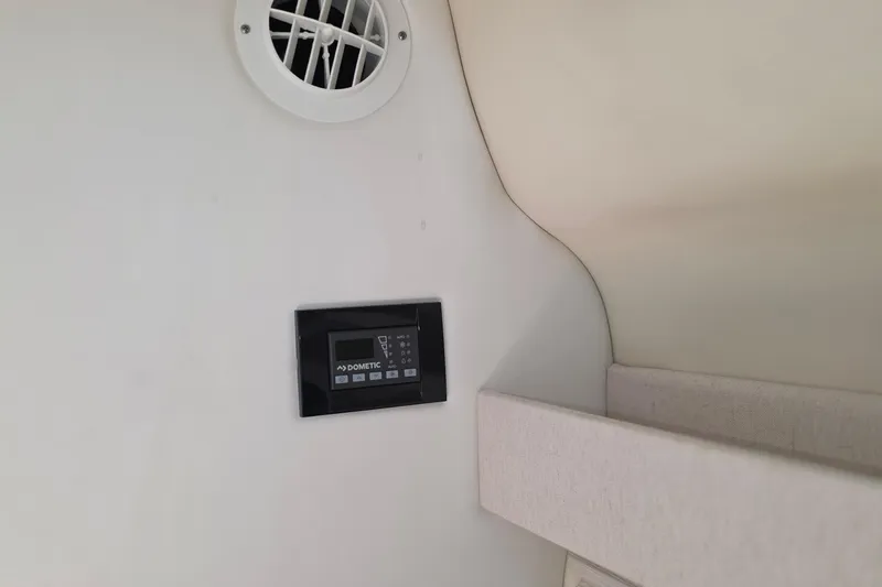 Slide: The Image of 2022 Regal 28 Express cabin interior with Dometic control panel and air vent. - 36