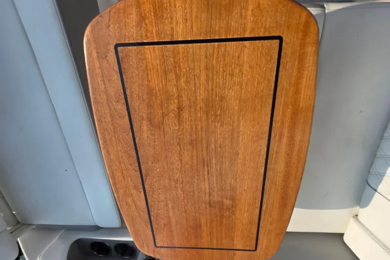 Slide: The Image of Wooden table surface on a 2022 Regal 28 Express boat interior. - 42