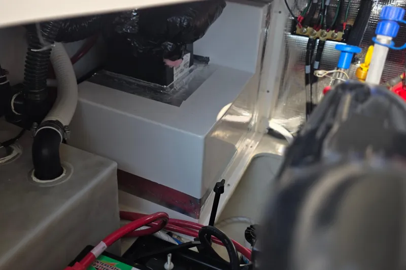 Slide: The Image of Engine compartment of a 2022 Regal 28 Express boat, showing hoses and wiring. - 46