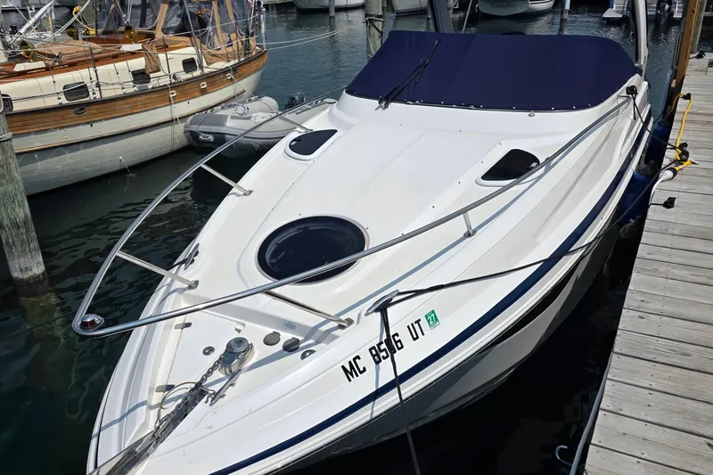 Slide: The Image of 2022 Regal 28 Express docked at a marina, surrounded by other boats. - 5