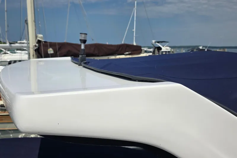 Slide: The Image of 2022 Regal 28 Express boat docked with blue cover in marina. - 9