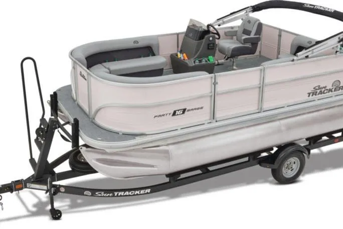 Slide: The Image of 2026 Sun Tracker Party Barge 16 DLX pontoon boat on trailer, side view. - 10