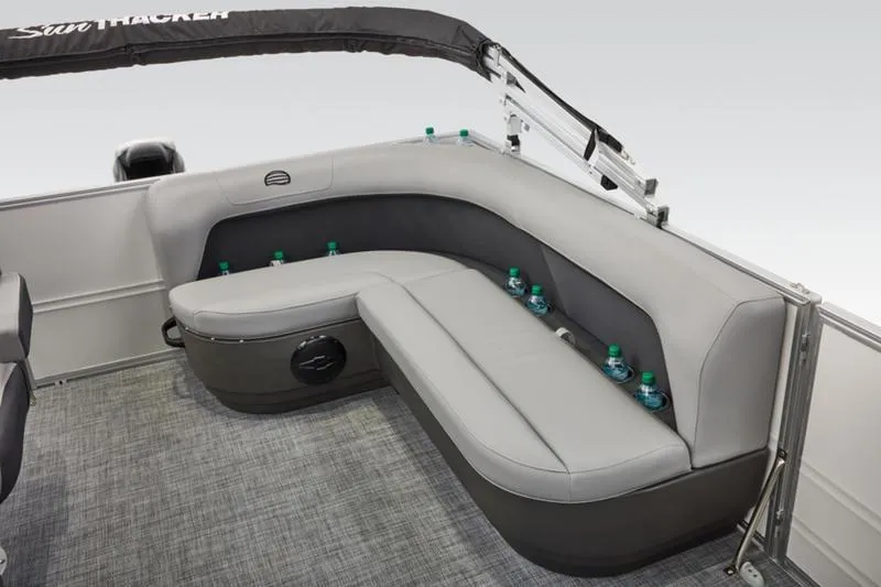 Slide: The Image of 2026 Sun Tracker Party Barge 16 DLX interior with gray seating and drink holders. - 12