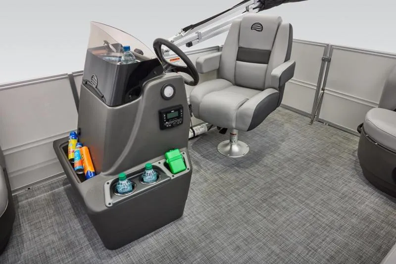 Slide: The Image of 2026 Sun Tracker Party Barge 16 DLX interior with captain's chair and control console. - 20