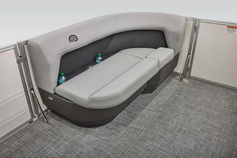 Slide: The Image of 2026 Sun Tracker Party Barge 16 DLX interior seating with gray upholstery and cup holders. - 21