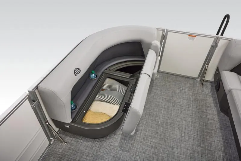 Slide: The Image of 2026 Sun Tracker Party Barge 16 DLX interior with storage under cushioned seating. - 23