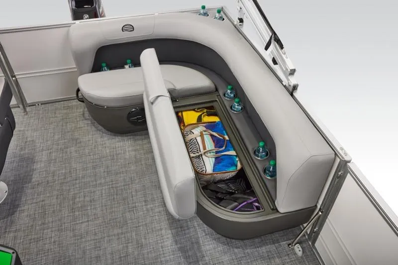 Slide: The Image of 2026 Sun Tracker Party Barge 16 DLX interior with storage and cup holders. - 26