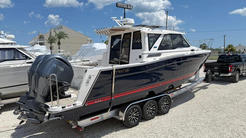 The Image of 2026 Cutwater C-288 Coupe boat on trailer, parked outdoors under a clear sky. - 0