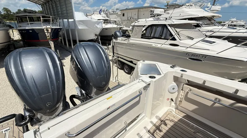 Slide: The Image of 2026 Cutwater C-288 Coupe with dual outboard engines in a marina setting. - 17