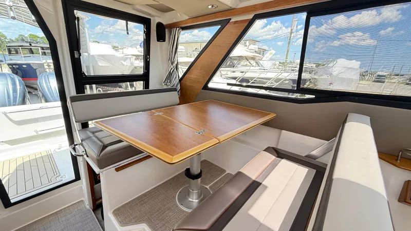 Slide: The Image of Interior of 2026 Cutwater C-288 Coupe with dining area and large windows. - 28