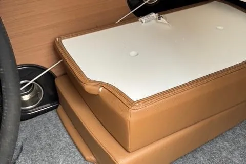 Slide: The Image of 2024 Yamaha Boats 222XD interior detail with tan cushions and storage compartment. - 11