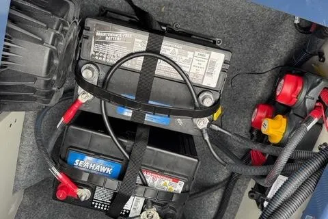Slide: The Image of 2024 Yamaha Boats 222XD battery compartment with maintenance-free and Seahawk batteries. - 16
