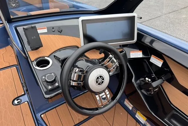 Slide: The Image of 2024 Yamaha Boats 222XD dashboard with steering wheel and touchscreen display. - 19