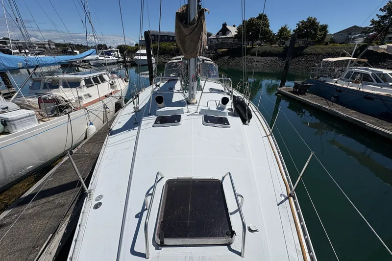 Slide: The Image of 1990 Beneteau Oceanis 500 sailboat docked in a marina, viewed from the deck. - 23