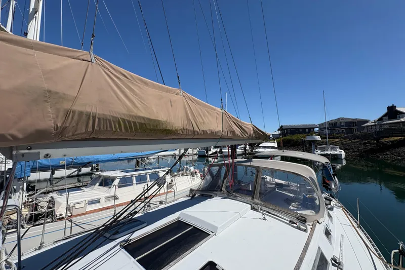 Slide: The Image of Sailboat Beneteau Oceanis 500, 1990 model, docked in a sunny marina. - 28