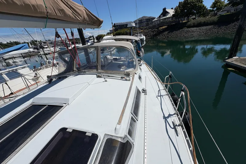 Slide: The Image of Beneteau Oceanis 500 sailboat docked in a marina, showcasing its deck and cockpit. - 43