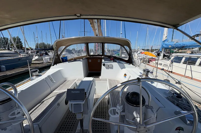 Slide: The Image of Cockpit view of 1990 Beneteau Oceanis 500 sailboat docked in marina. - 52