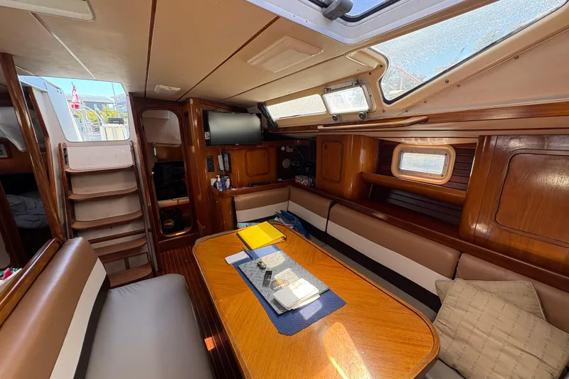 Slide: The Image of Interior of 1990 Beneteau Oceanis 500 sailboat with wood finish and seating area. - 60