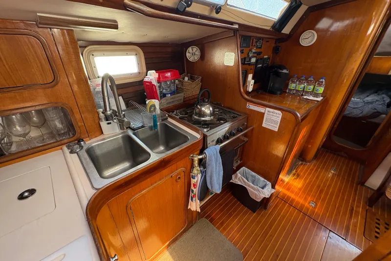 Slide: The Image of Cozy kitchen in 1990 Beneteau Oceanis 500 sailboat with wooden cabinetry and dual sink. - 67