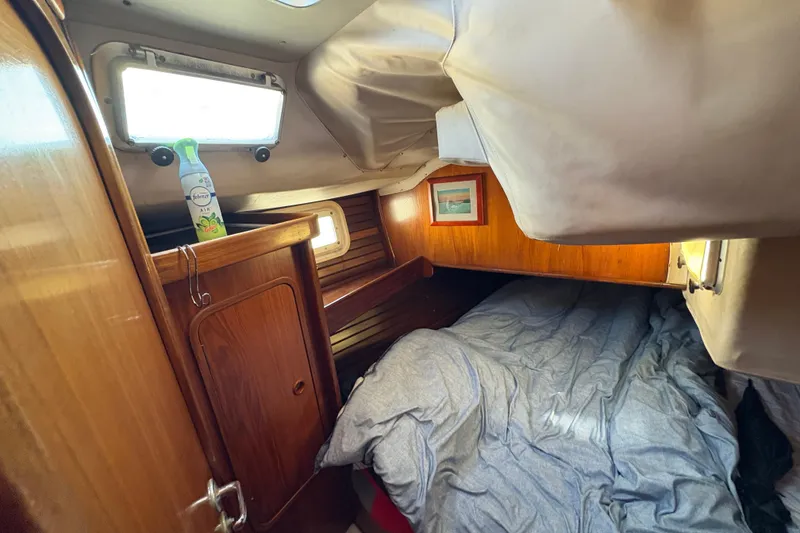 Slide: The Image of Cozy cabin interior of 1990 Beneteau Oceanis 500 sailboat with wooden finish and bedding. - 84