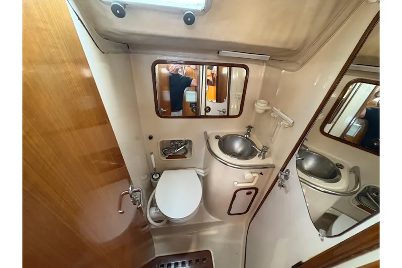 Slide: The Image of Bathroom interior of 1990 Beneteau Oceanis 500 yacht, featuring sink and toilet. - 86