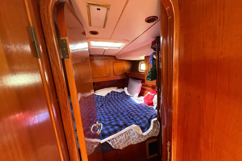 Slide: The Image of Cozy cabin interior of 1990 Beneteau Oceanis 500 sailboat with wooden finish and bed. - 95