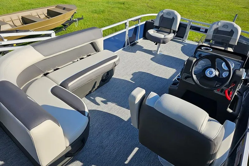 Slide: The Image of 2026 Sun Tracker Bass Buggy 18 DLX pontoon boat interior with seating and steering console. - 10