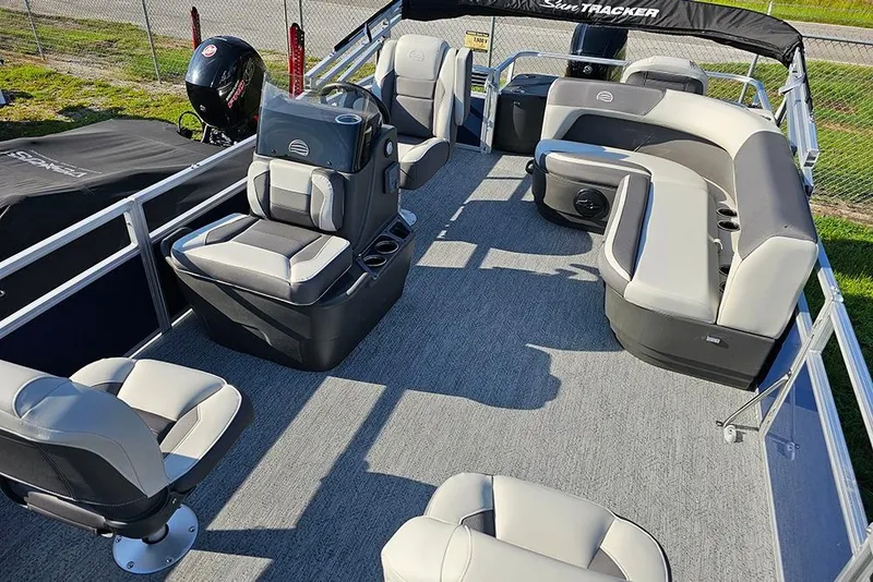 Slide: The Image of 2026 Sun Tracker Bass Buggy 18 DLX pontoon boat interior with seating and steering console. - 11