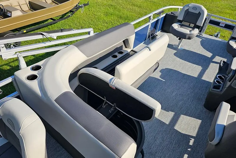 Slide: The Image of 2026 Sun Tracker Bass Buggy 18 DLX pontoon boat interior with seating and cup holders. - 14