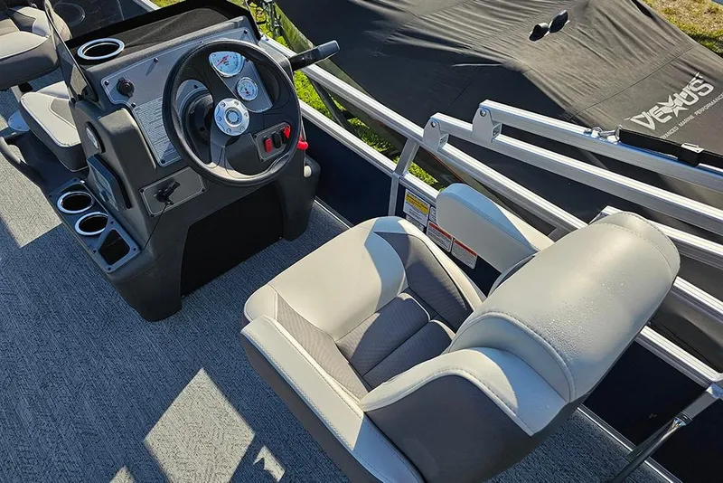 Slide: The Image of 2026 Sun Tracker Bass Buggy 18 DLX boat interior with steering console and seating. - 15