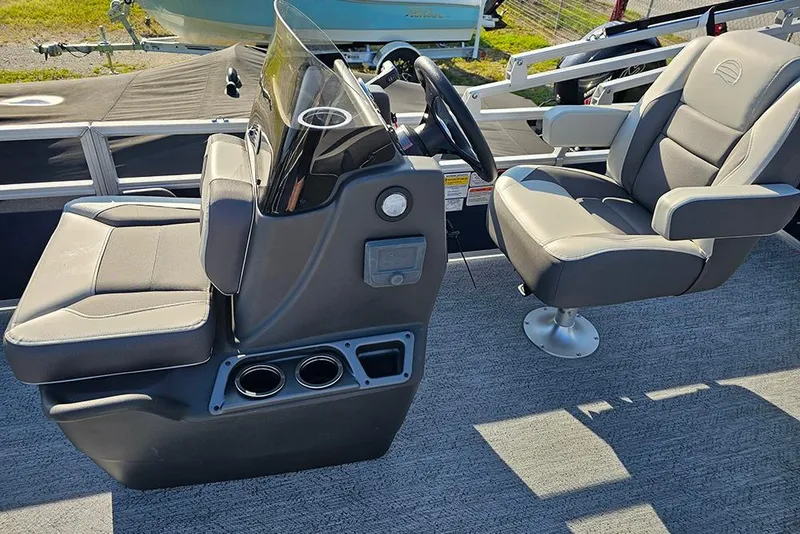 Slide: The Image of 2026 Sun Tracker Bass Buggy 18 DLX interior with steering console and seating. - 18