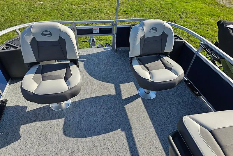 Slide: The Image of 2026 Sun Tracker Bass Buggy 18 DLX boat interior with two swivel seats on deck. - 19